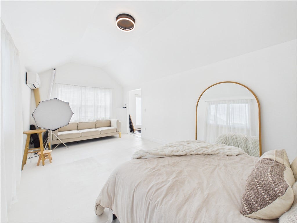 36 Bellevue Avenue, North Smithfield, RI 02896 Bright creative studio space currently used for photography, featuring a spacious open layout, abundant natural light, and a mini-split system for heating and cooling.