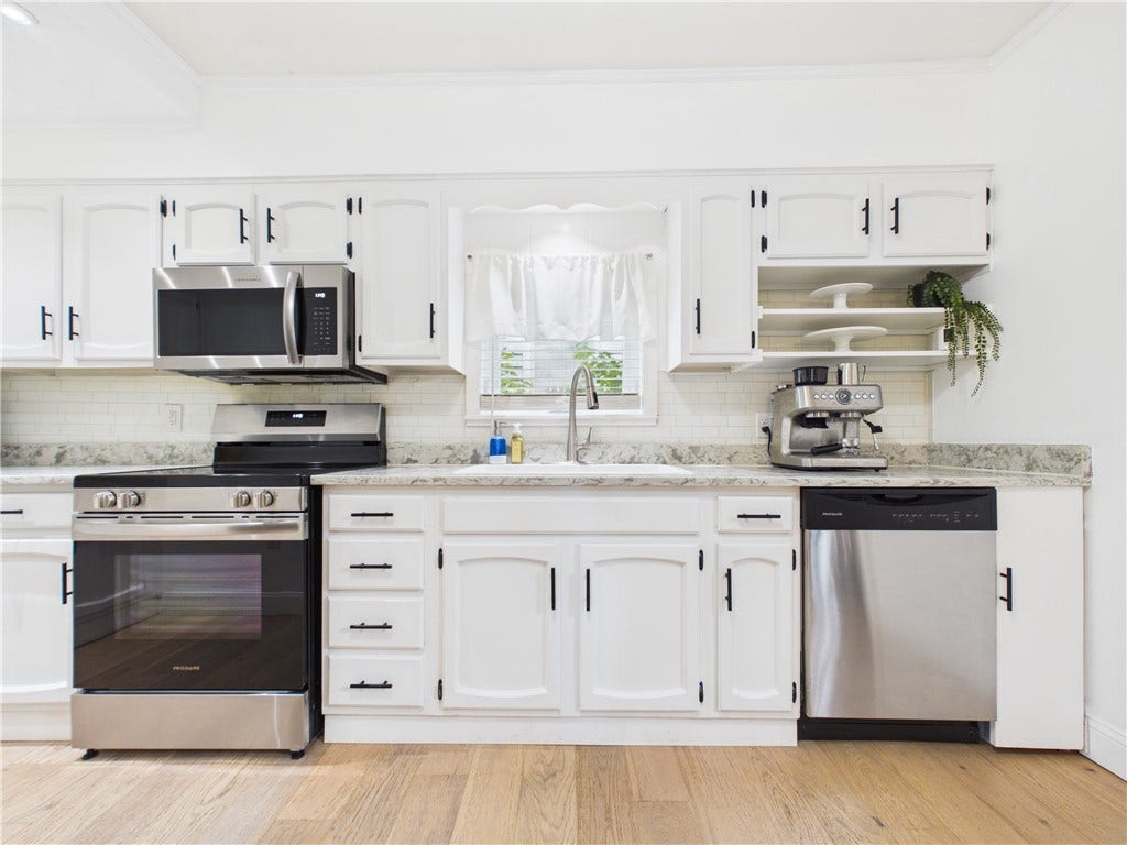 36 Bellevue Avenue, North Smithfield, RI 02896 Stainless steel oven/range, dishwasher, and microwave complement the kitchen at 36 Bellevue Avenue, featuring granite countertops and a functional layout designed for everyday living.
