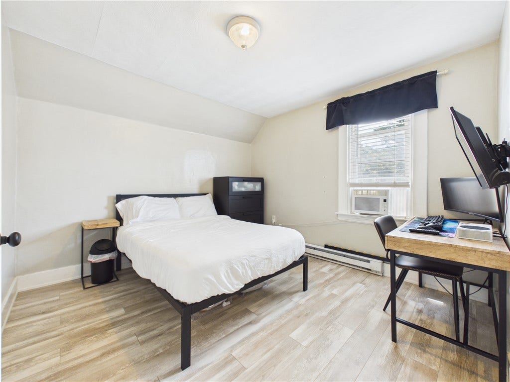 36 Bellevue Avenue, North Smithfield, RI 02896 Fourth second-floor bedroom at 36 Bellevue Avenue, offering a versatile layout with room for bedroom furniture and a dedicated desk or work area.