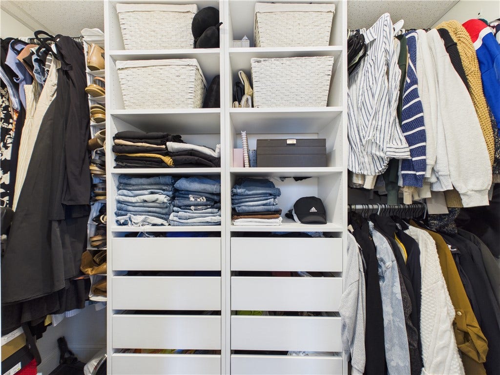 36 Bellevue Avenue, North Smithfield, RI 02896 Walk-in closet in the primary suite at 36 Bellevue Avenue, featuring built-in shelving, hanging space, and drawer storage for organized everyday living.