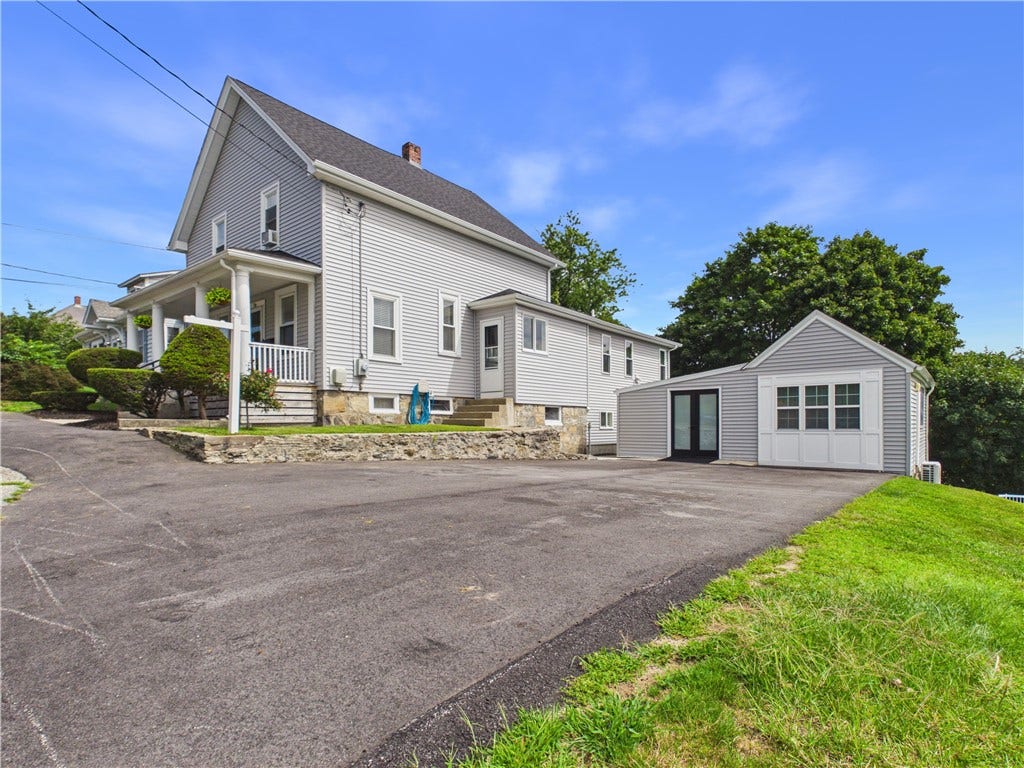 36 Bellevue Avenue, North Smithfield, RI 02896 Side exterior view of this North Smithfield home, highlighting the expanded footprint and versatile layout of 36 Bellevue Avenue.