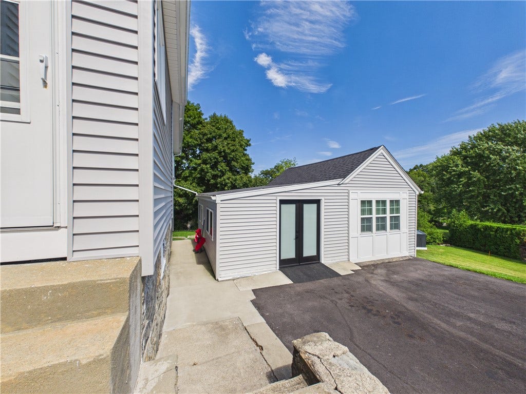36 Bellevue Avenue, North Smithfield, RI 02896 Converted former garage at 36 Bellevue Avenue in North Smithfield, RI, offering a separate flexible space with its own exterior entrance and room for creative, office, or studio use.