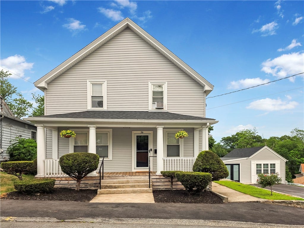 36 Bellevue Avenue, North Smithfield, RI 02896 Front exterior of 36 Bellevue Avenue in North Smithfield, RI, a spacious five-bedroom home offering approximately 3,257 square feet of flexible living space.