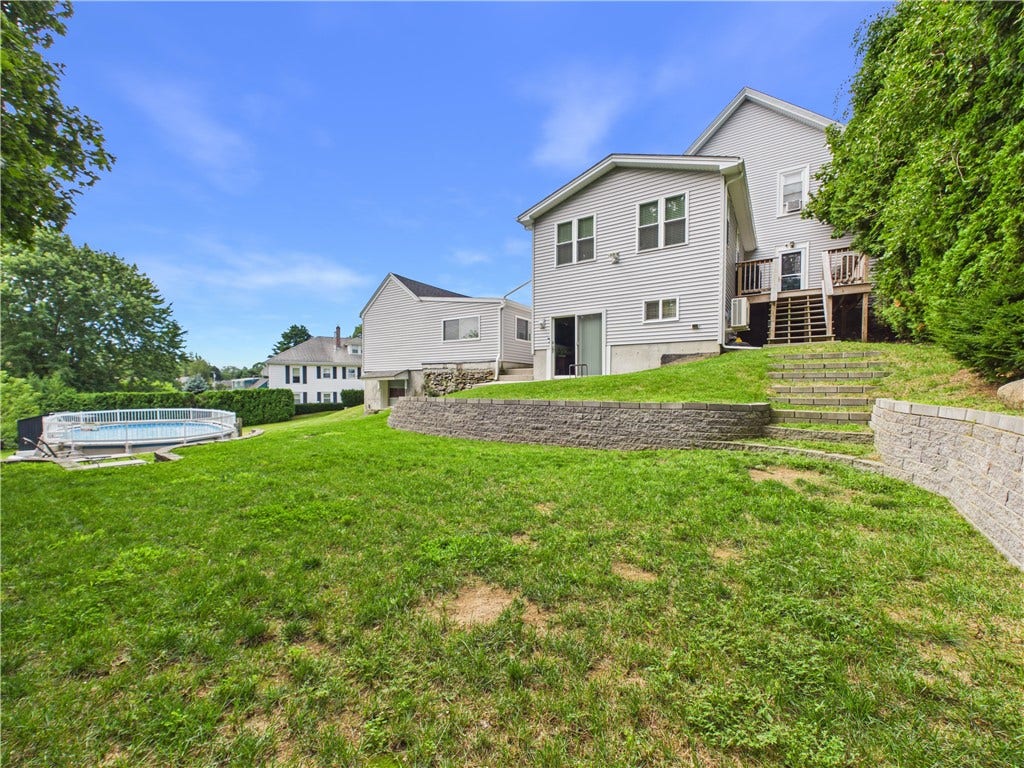 36 Bellevue Avenue, North Smithfield, RI 02896 Backyard with above-ground pool at this North Smithfield home, situated on an approximately 14,941-square-foot lot.
