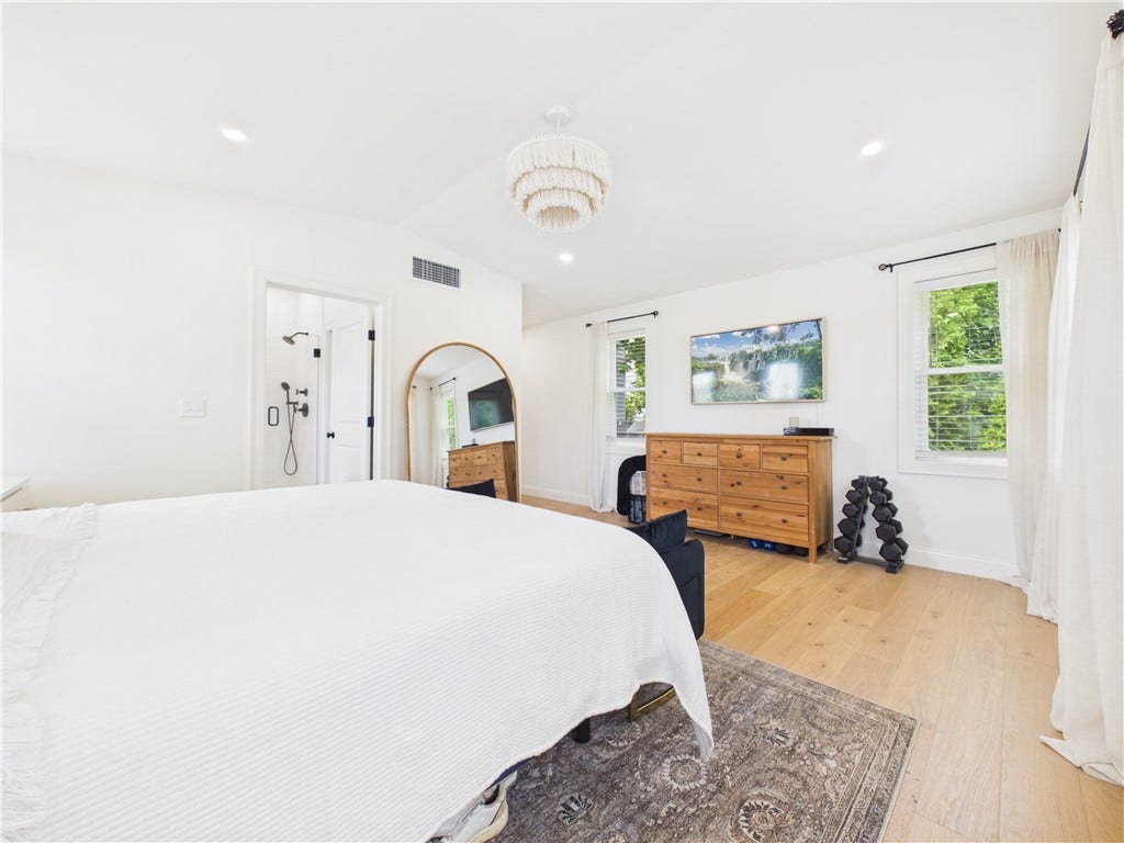 36 Bellevue Avenue, North Smithfield, RI 02896 Another view of the primary bedroom showcasing multiple windows, generous proportions, and a comfortable layout with room for additional furniture.