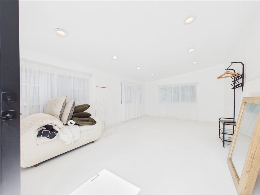 36 Bellevue Avenue, North Smithfield, RI 02896 Wide interior view of the converted garage at 36 Bellevue Avenue, offering a bright, versatile bonus space separate from the main living areas of the home.