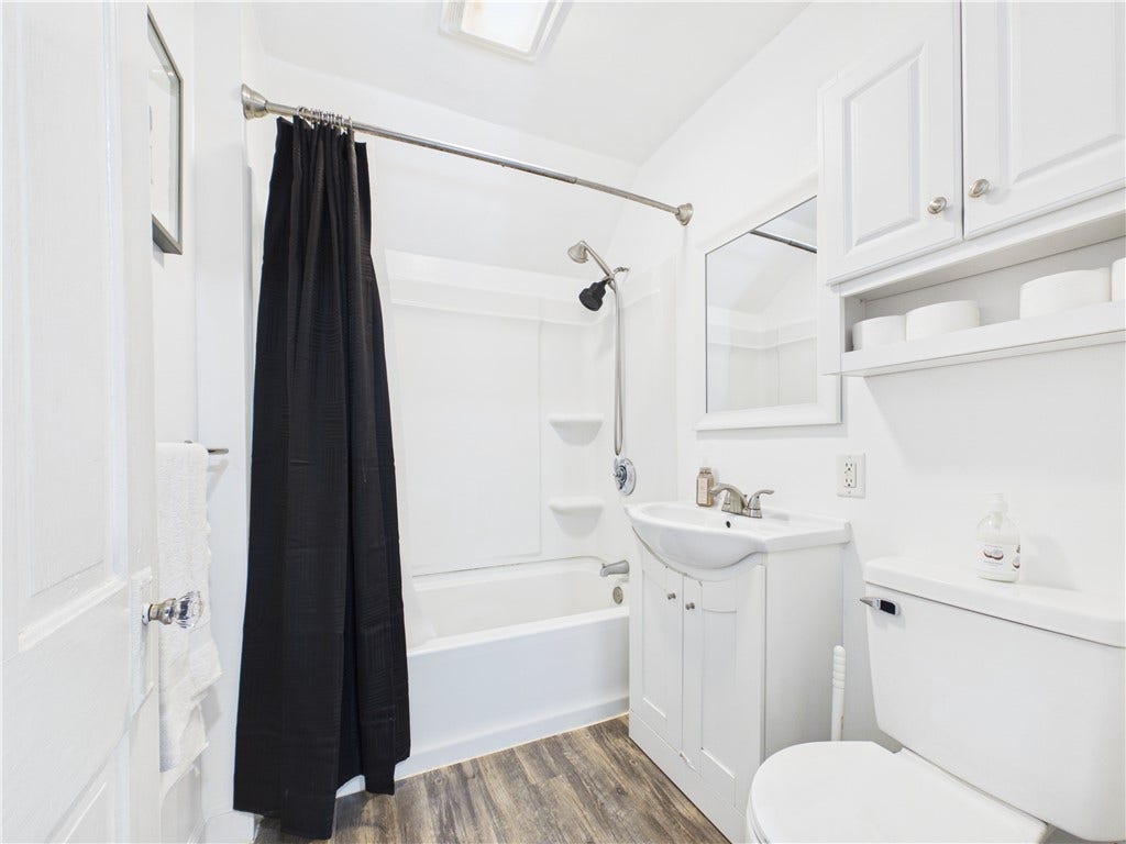 36 Bellevue Avenue, North Smithfield, RI 02896 Full bathroom serving the second floor, featuring a tub and shower combination, vanity storage, and bright neutral finishes.