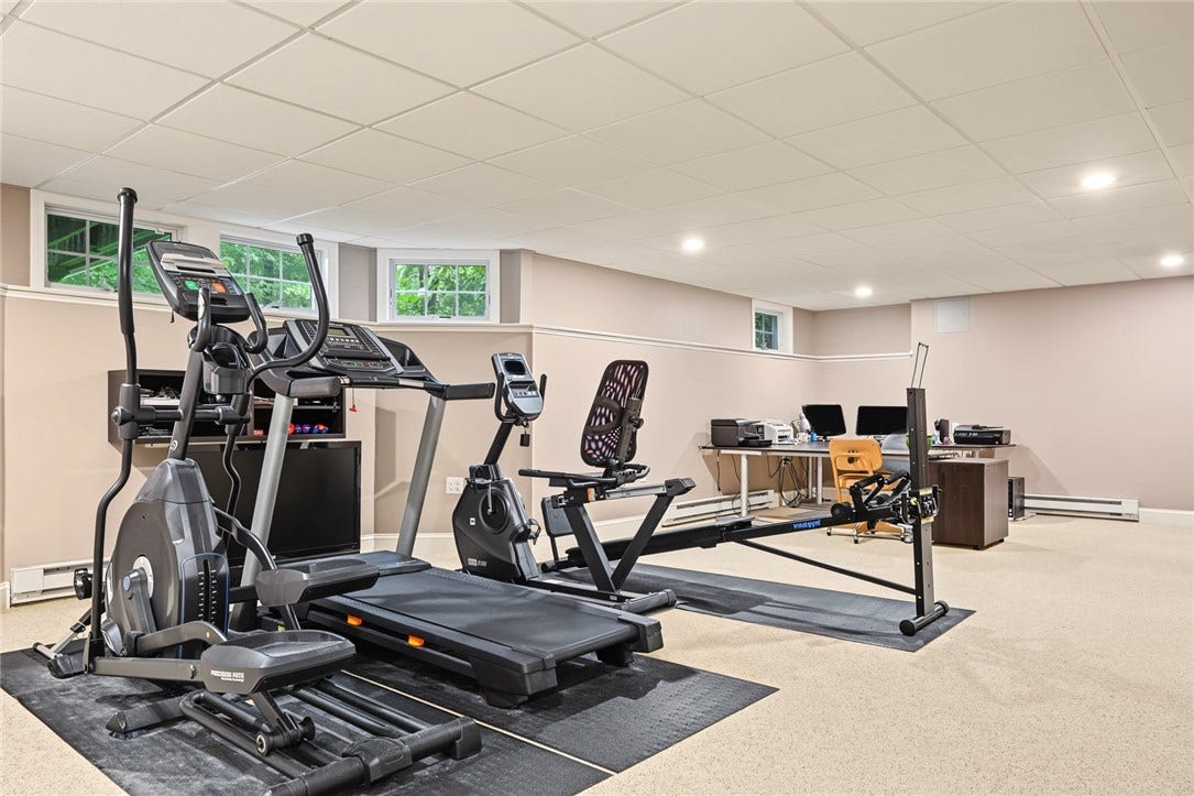 95 Fry Brook Drive, East Greenwich, RI 02818 Fitness area with space for multiple exercise stations, complemented by recessed lighting and natural light.