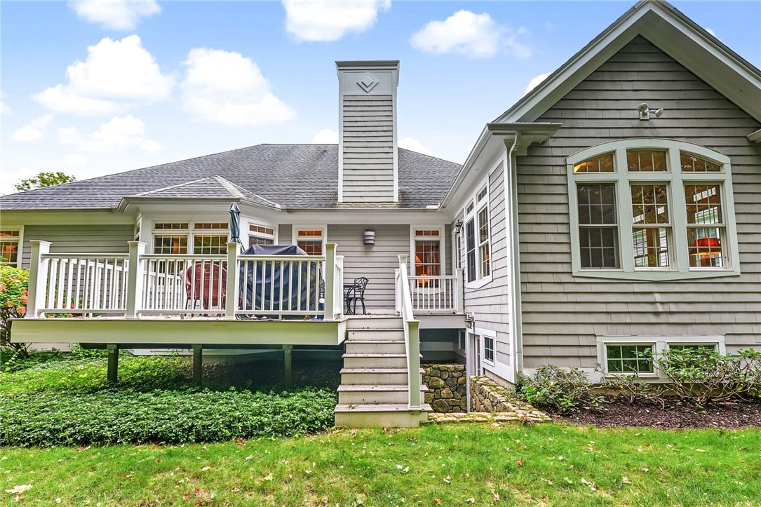 95 Fry Brook Drive, East Greenwich, RI 02818 A lush lawn and mature greenery with access to the lower-level.