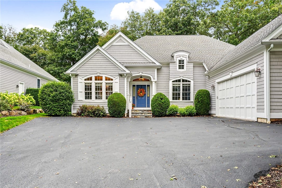 95 Fry Brook Drive, East Greenwich, RI 02818 A gracious covered entry, daramatic arched windows and an attached two-car garage.
