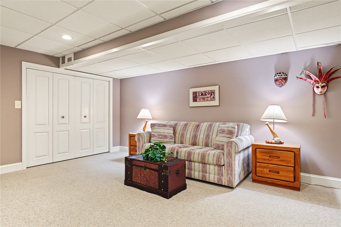 95 Fry Brook Drive, East Greenwich, RI 02818 A spacious finished lower-level living area offering exceptional flexibility for a family room, media space, game room, or guest retreat.