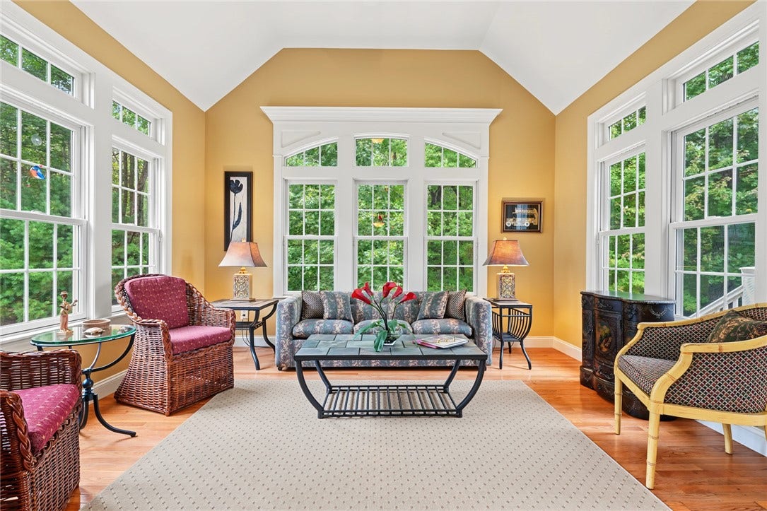 95 Fry Brook Drive, East Greenwich, RI 02818 An airy and inviting sun room with beautiful natural light and views of the surrounding greenery.