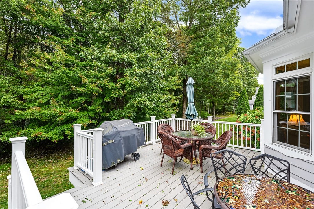 95 Fry Brook Drive, East Greenwich, RI 02818 A lush, private wooded setting ideal for entertaining and outdoor relaxation.
