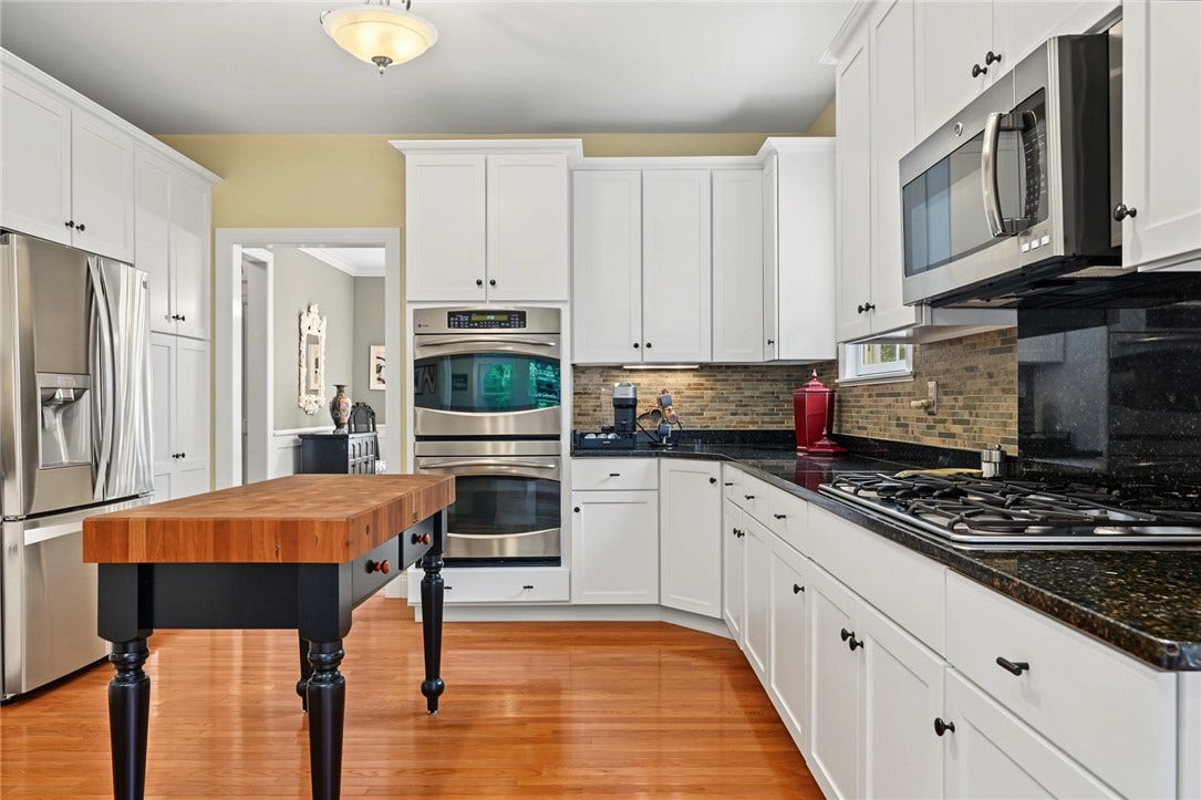 95 Fry Brook Drive, East Greenwich, RI 02818 A chef's kitchen with double wall ovens, gas cooktop.