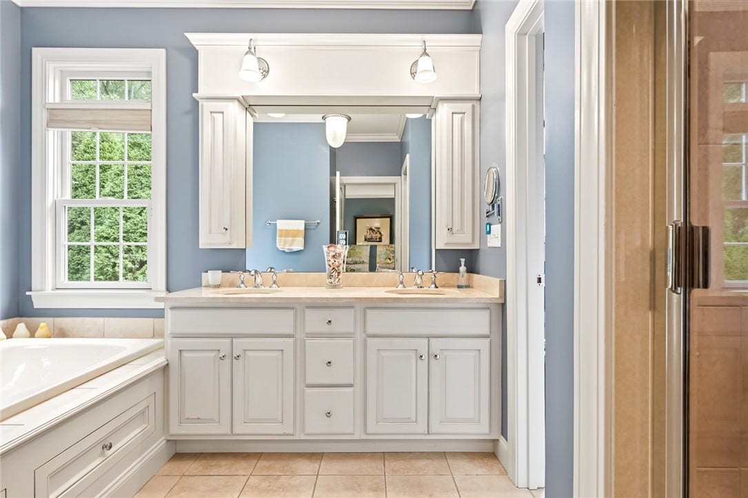 95 Fry Brook Drive, East Greenwich, RI 02818 Dual vanities, custom cabinetry and oversized windows fill the space with natural light.