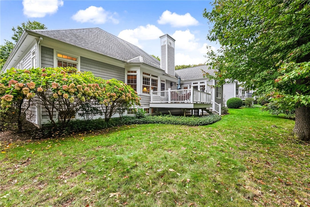95 Fry Brook Drive, East Greenwich, RI 02818 Beautifully landscaped yard framed by mature trees and established plantings for a peaceful, private setting.