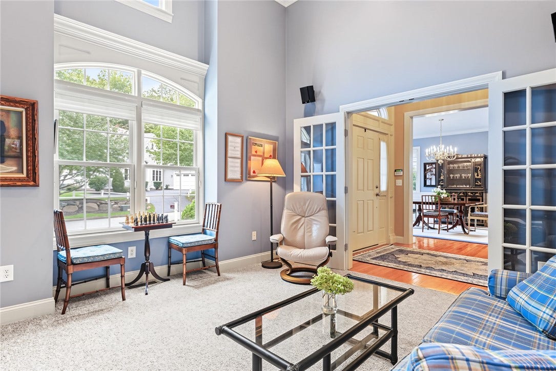 95 Fry Brook Drive, East Greenwich, RI 02818 A light-filled den featuring a valuted ceiling, dramatic arched windows and French doors.