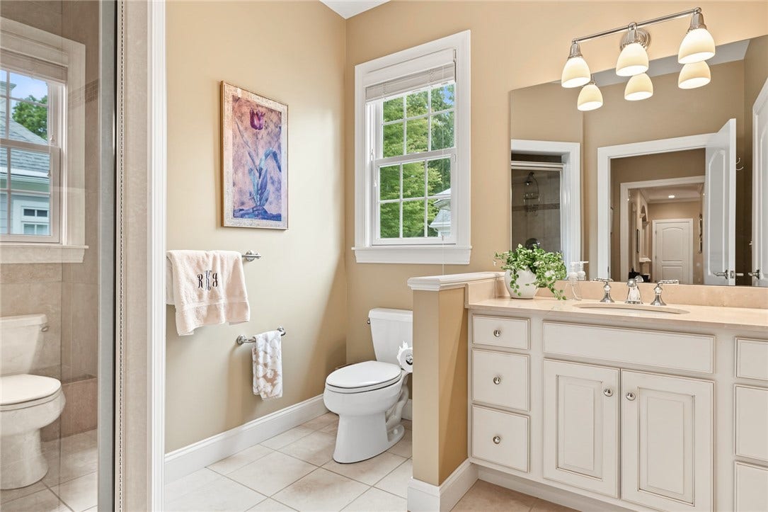95 Fry Brook Drive, East Greenwich, RI 02818 Full bath featuring a generous vanity with abundant storage, an oversized mirror, tiled flooring, and a walk-in shower.