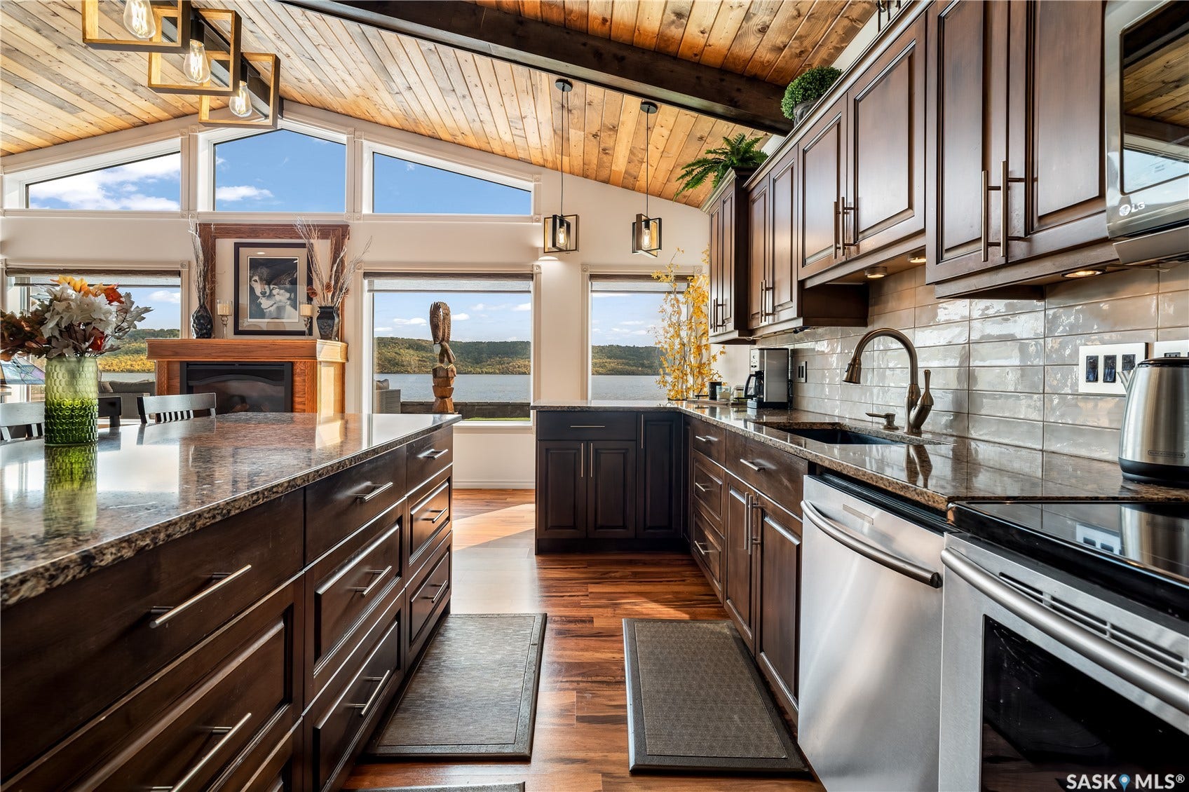 Kitchen open to large windows overlooking the lake