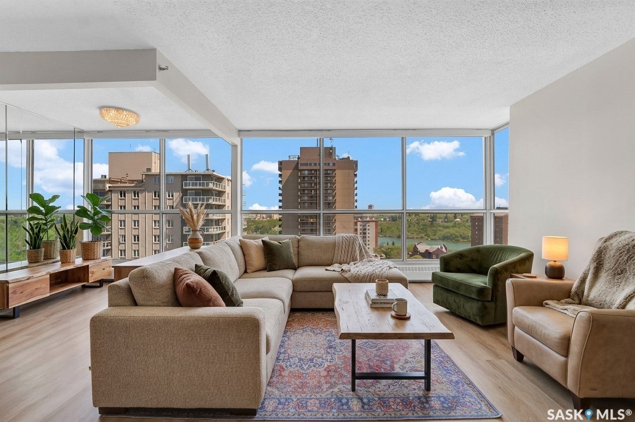 Expansive window walls, wood-finish flooring, and a flush mount ceiling light fixture