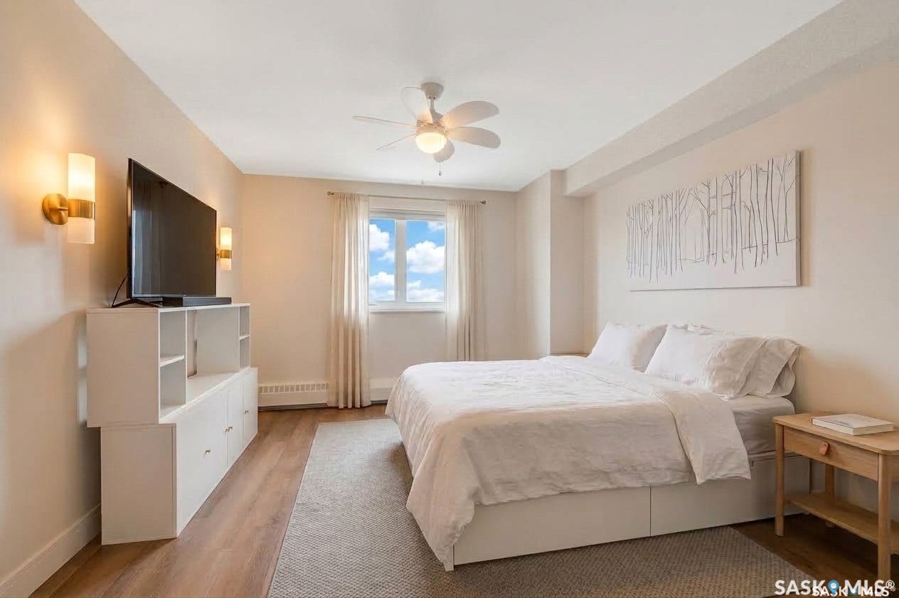 Wood-finish flooring, ceiling fan, and built-in wall sconces