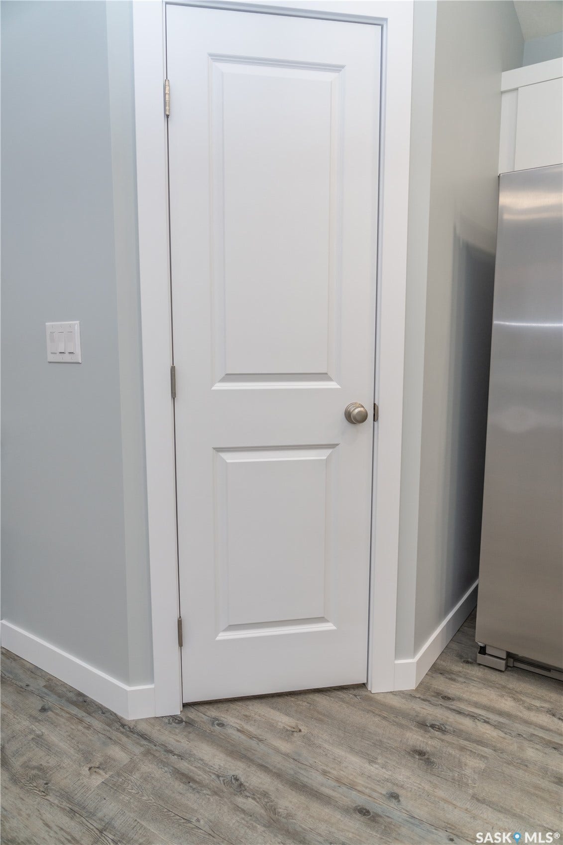318 Stehwien Street, Saskatoon SK S7W 1H5 Room details with light wood-type flooring and stainless steel refrigerator