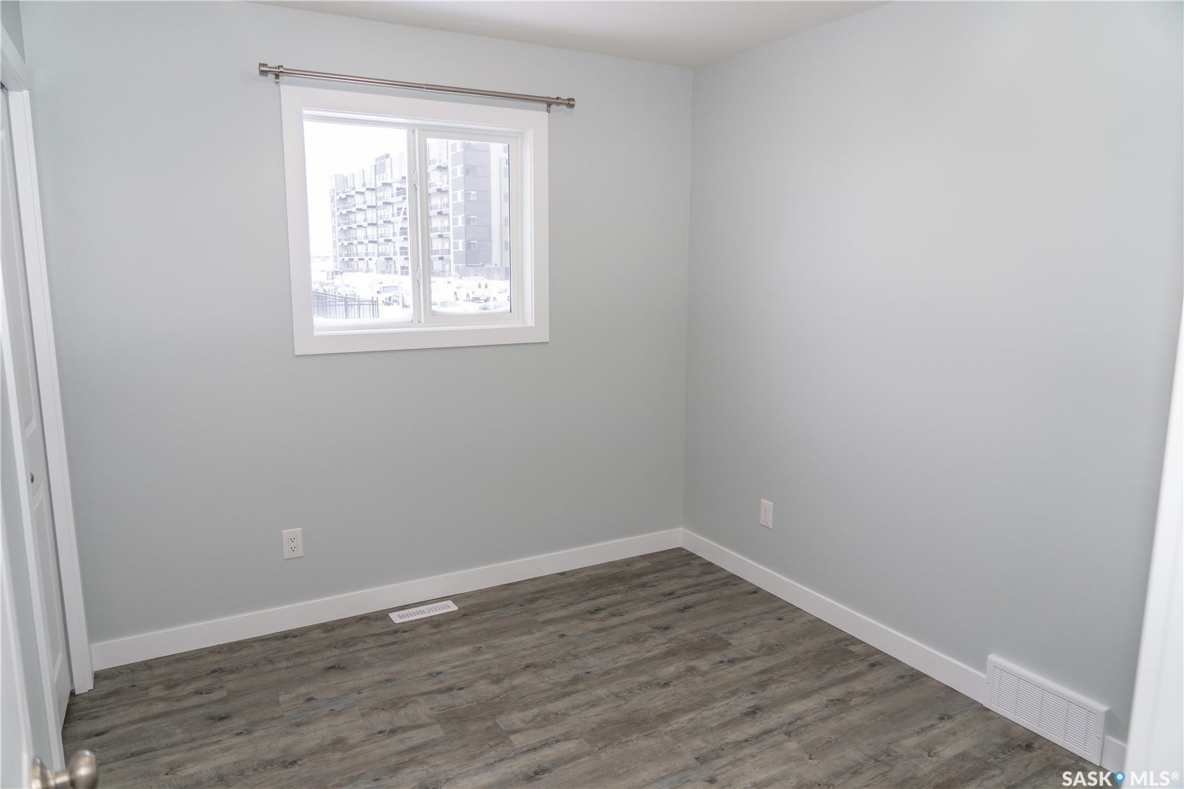 318 Stehwien Street, Saskatoon SK S7W 1H5 Spare room with dark hardwood / wood-style flooring
