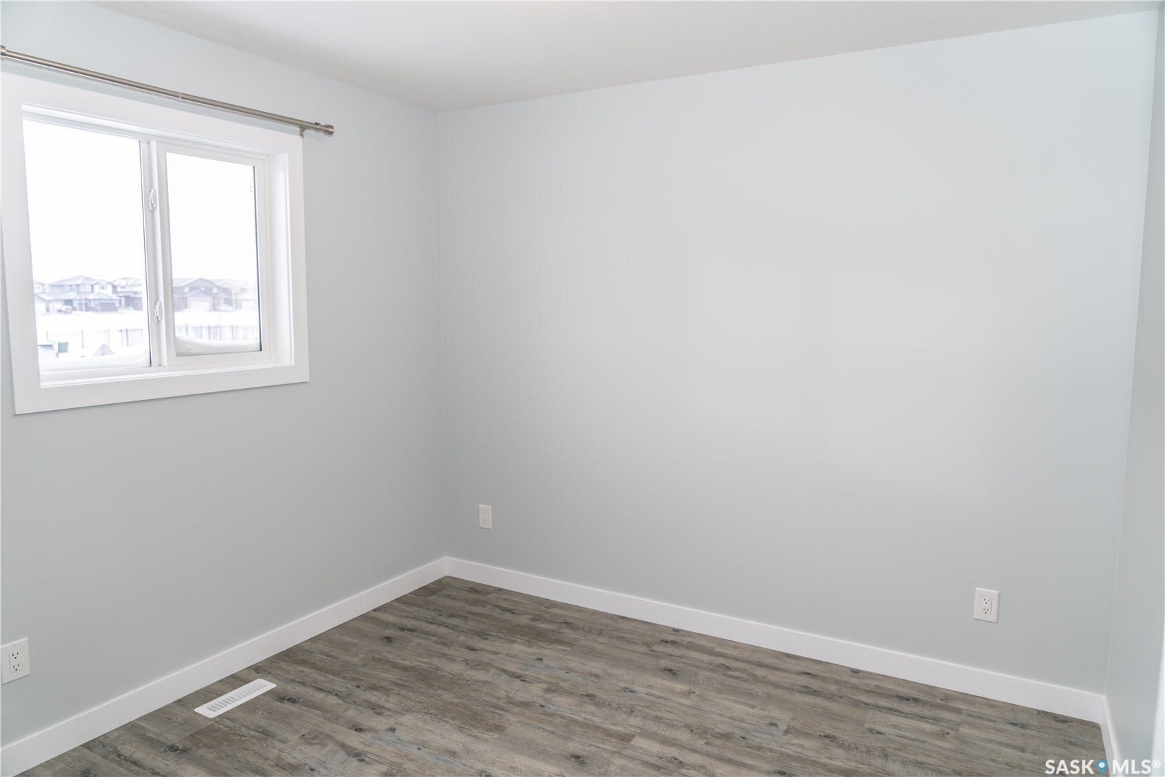 318 Stehwien Street, Saskatoon SK S7W 1H5 Spare room with dark wood-type flooring