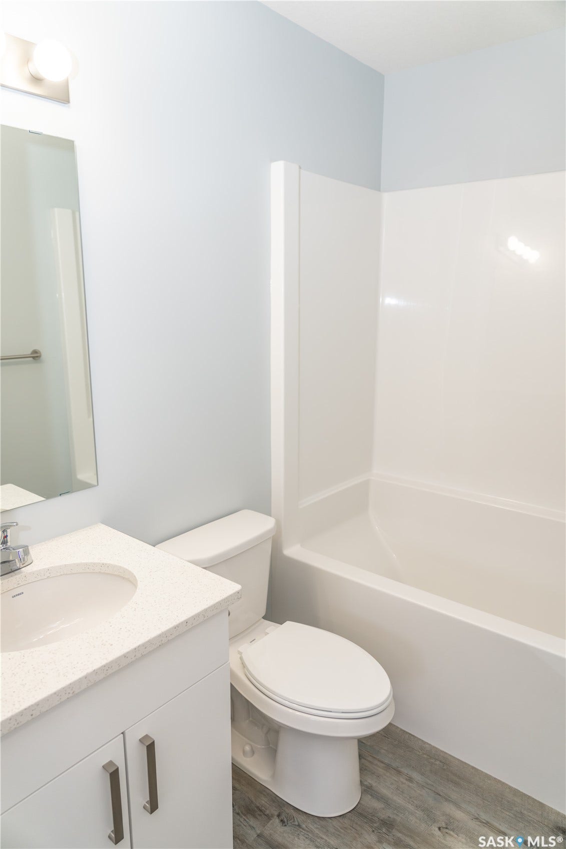 318 Stehwien Street, Saskatoon SK S7W 1H5 Full bathroom with toilet, large vanity, shower / washtub combination, and hardwood / wood-style flooring