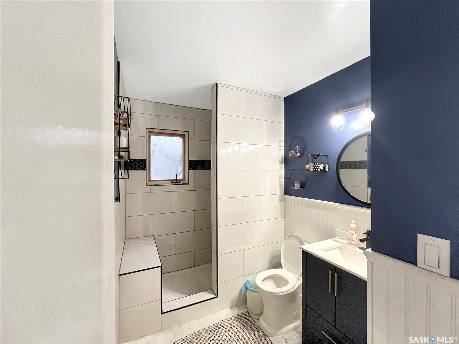 Walk-in shower with tiled walls and built-in bench