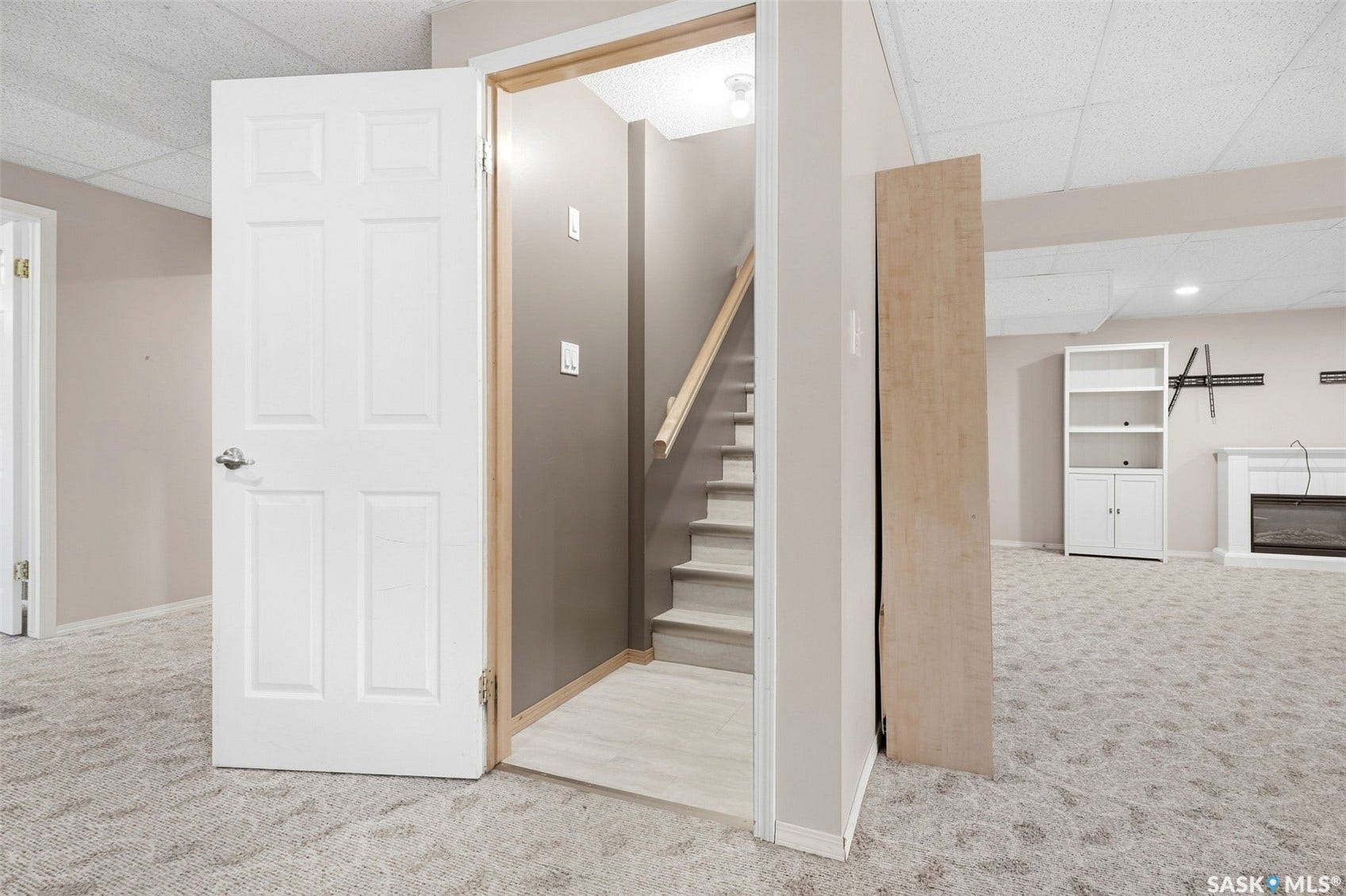 Finished lower level featuring neutral carpeting, a built-in electric fireplace, and recessed lighting