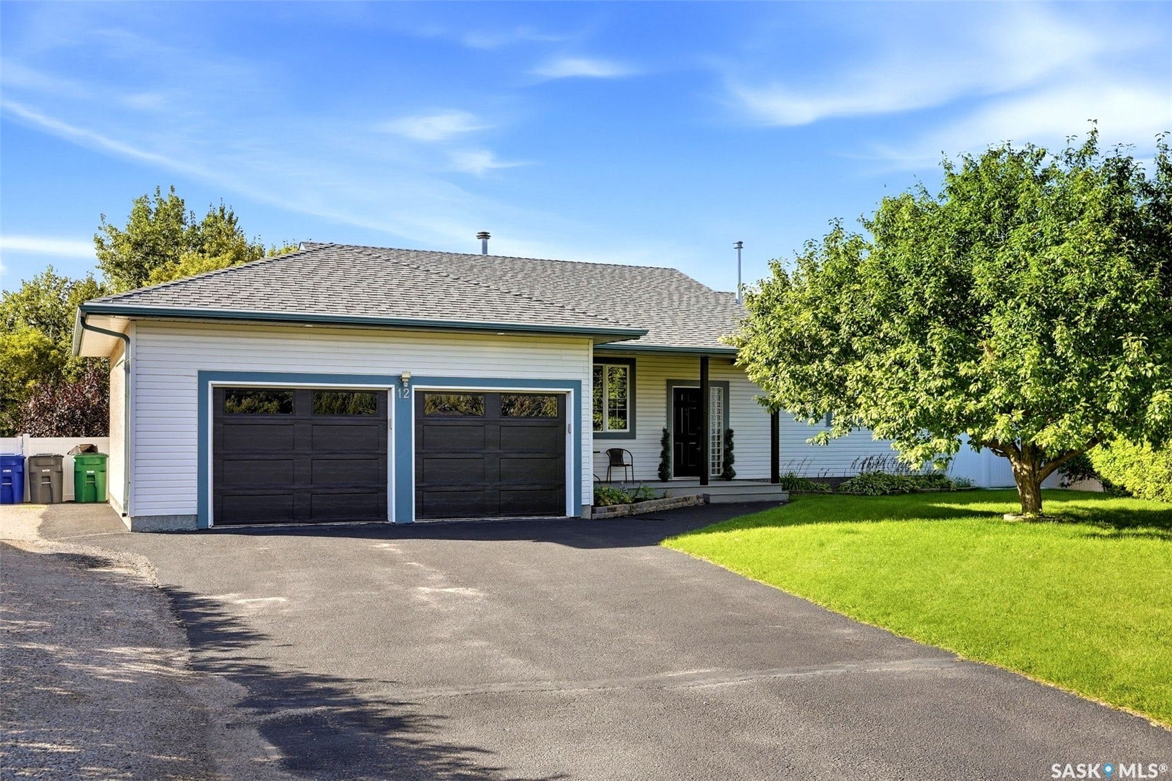 Single-story residence featuring light-colored siding and a dark shingled roof