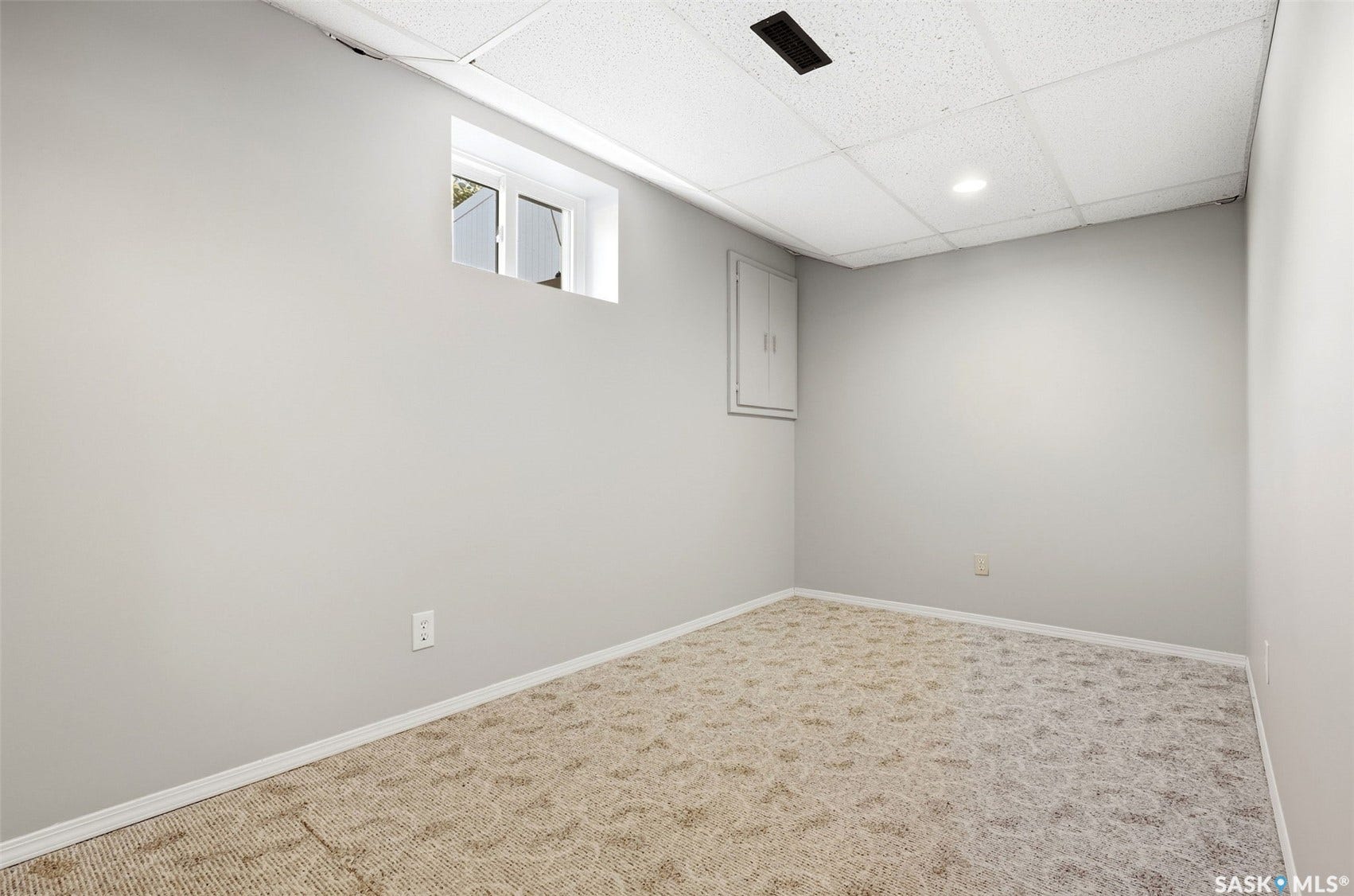 Recessed lighting with a drop ceiling, light gray painted walls, and patterned carpet flooring