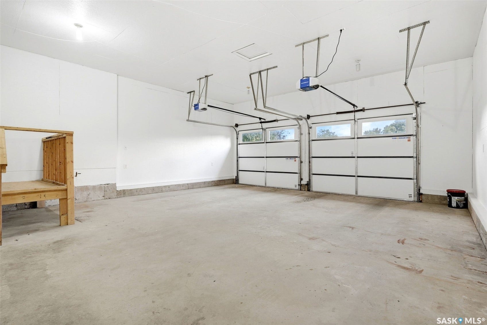 Two overhead garage doors with frosted window panels and automatic openers