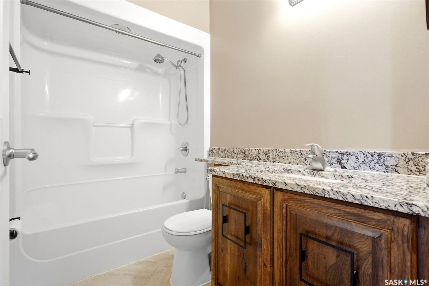 White fiberglass tub/shower combination with a built-in shelf