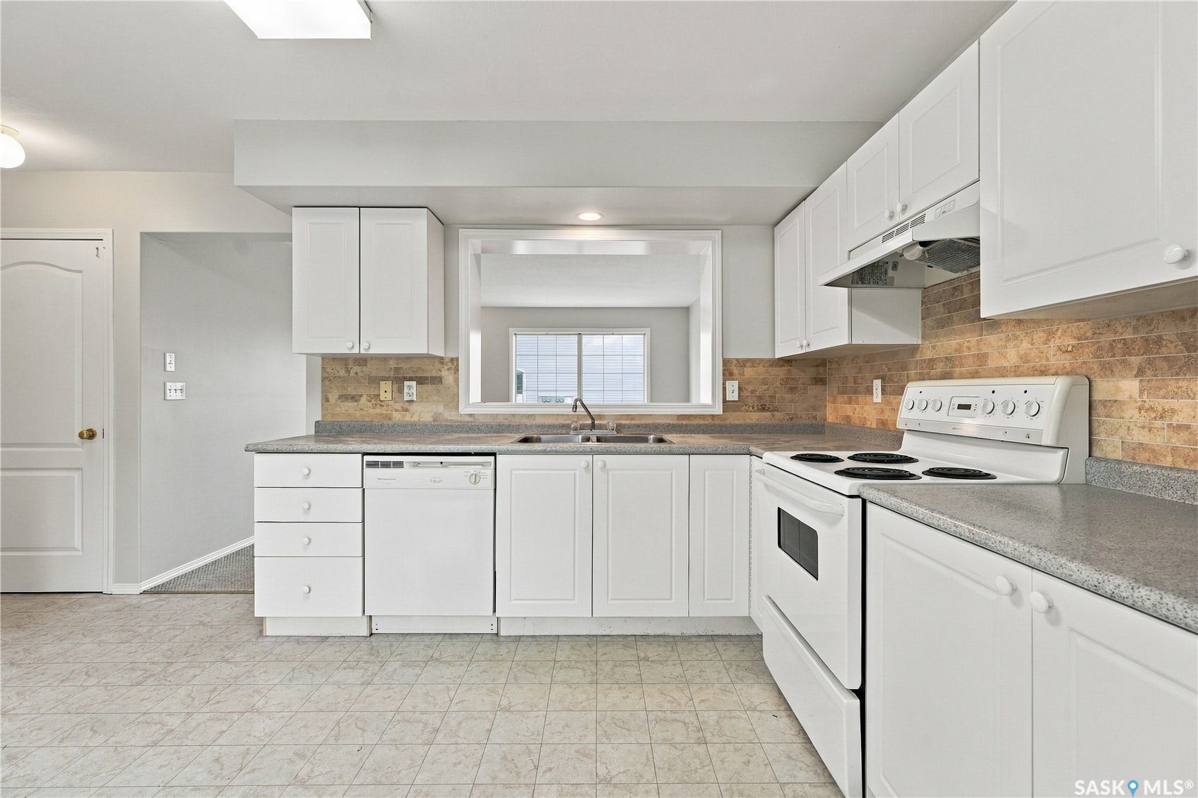 Kitchen featuring white cabinetry, a tiled backsplash, built-in dishwasher, and a white electric range