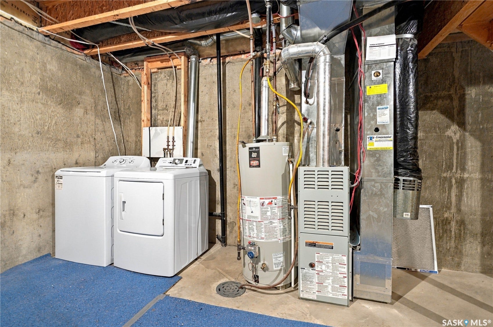 Utility area featuring a furnace, water heater, and concrete flooring