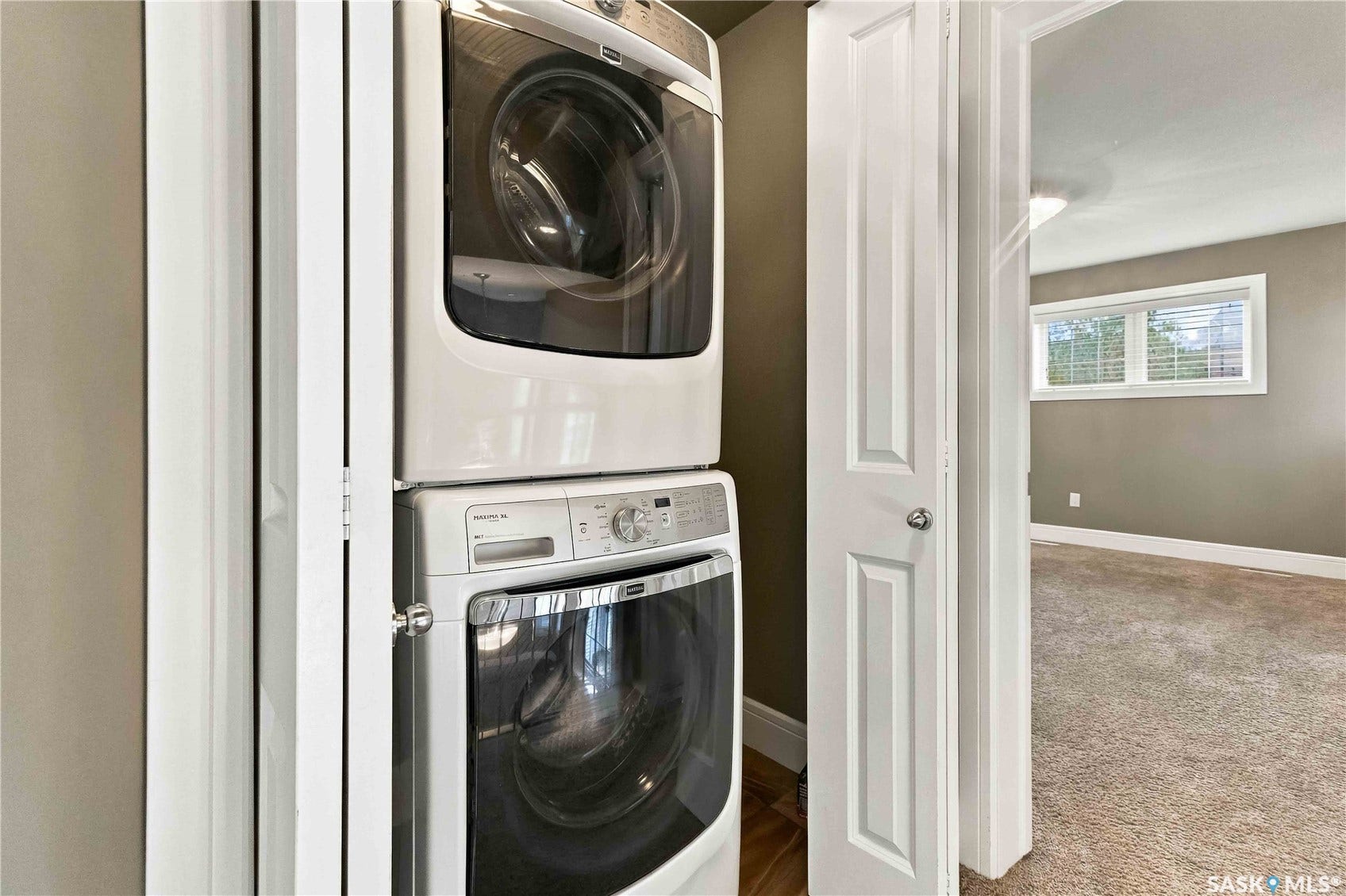 Stackable laundry appliances within a dedicated alcove
