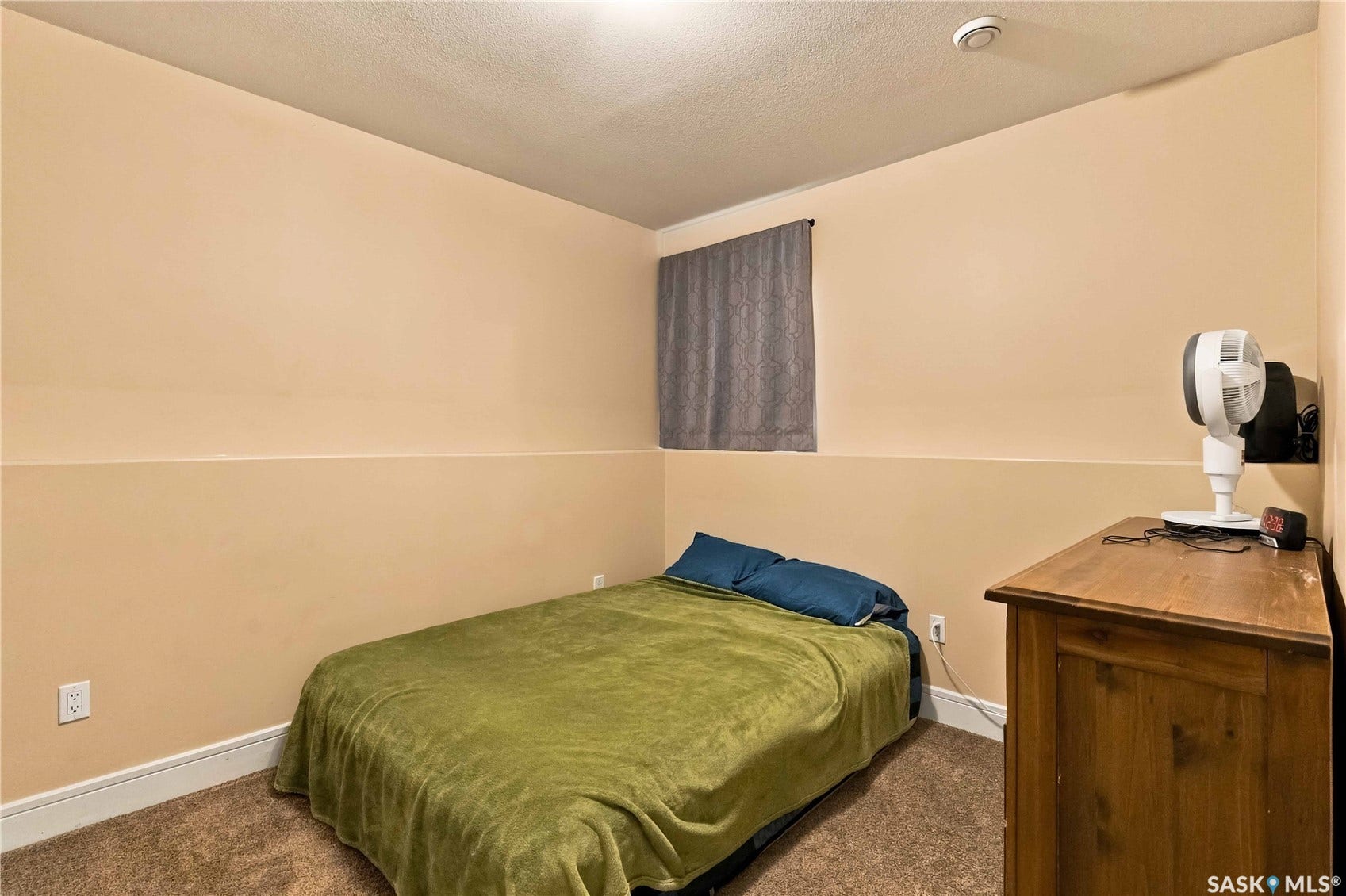 Carpeted room with neutral painted walls and a window