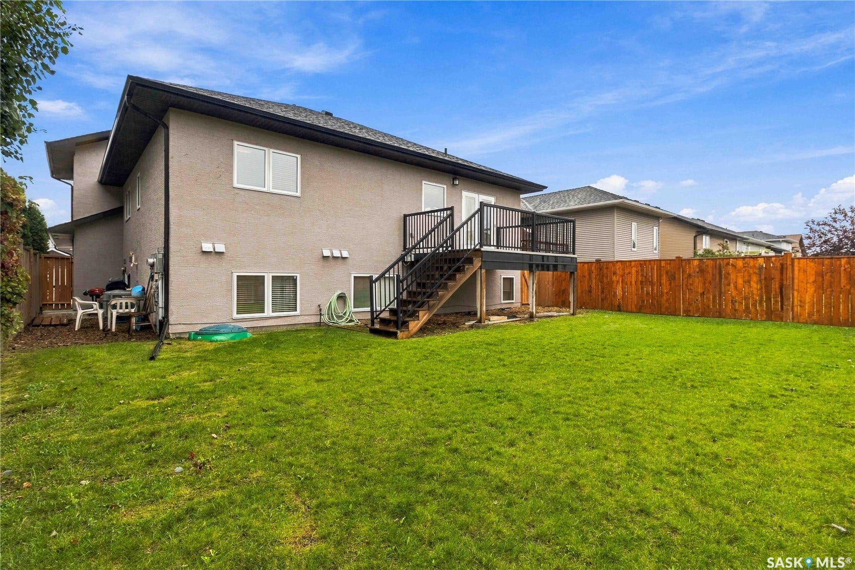 Expansive grass lawn with a wood fence perimeter