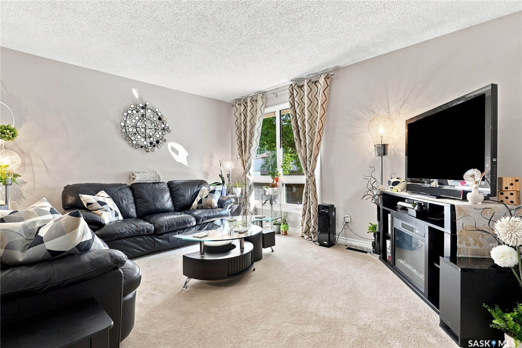 Neutral wall paint, textured ceiling, and carpeted flooring