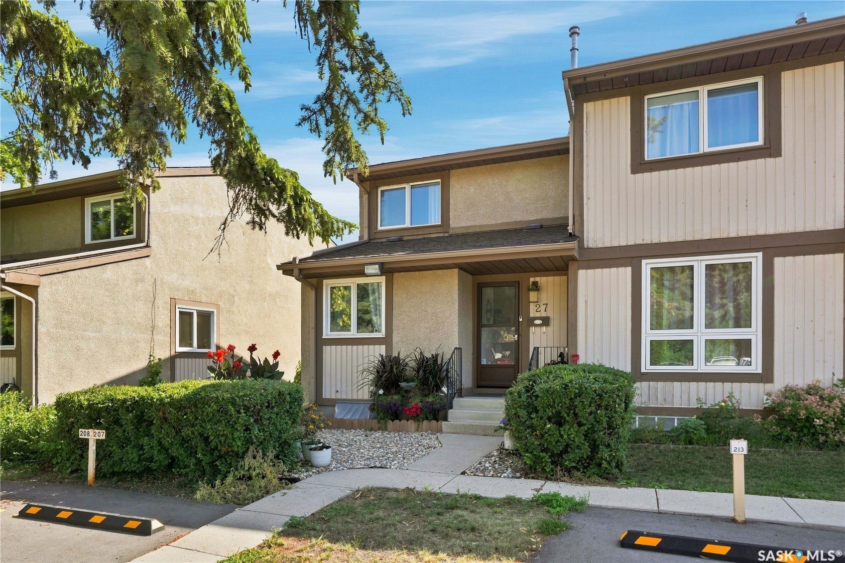 Two-story exterior with a combination of stucco and vertical panel siding