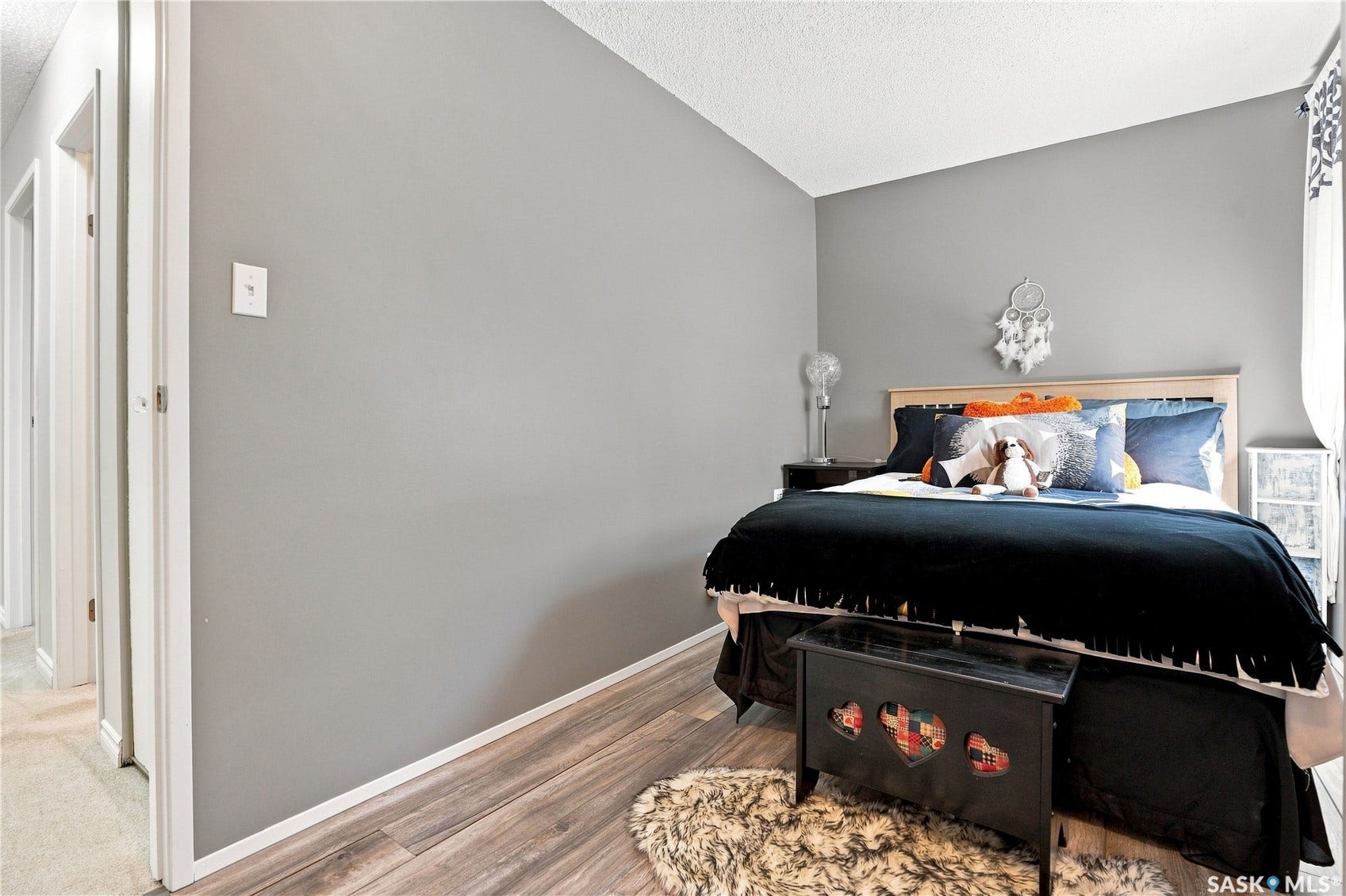 Wood-finish flooring with light gray wall paint and white trim