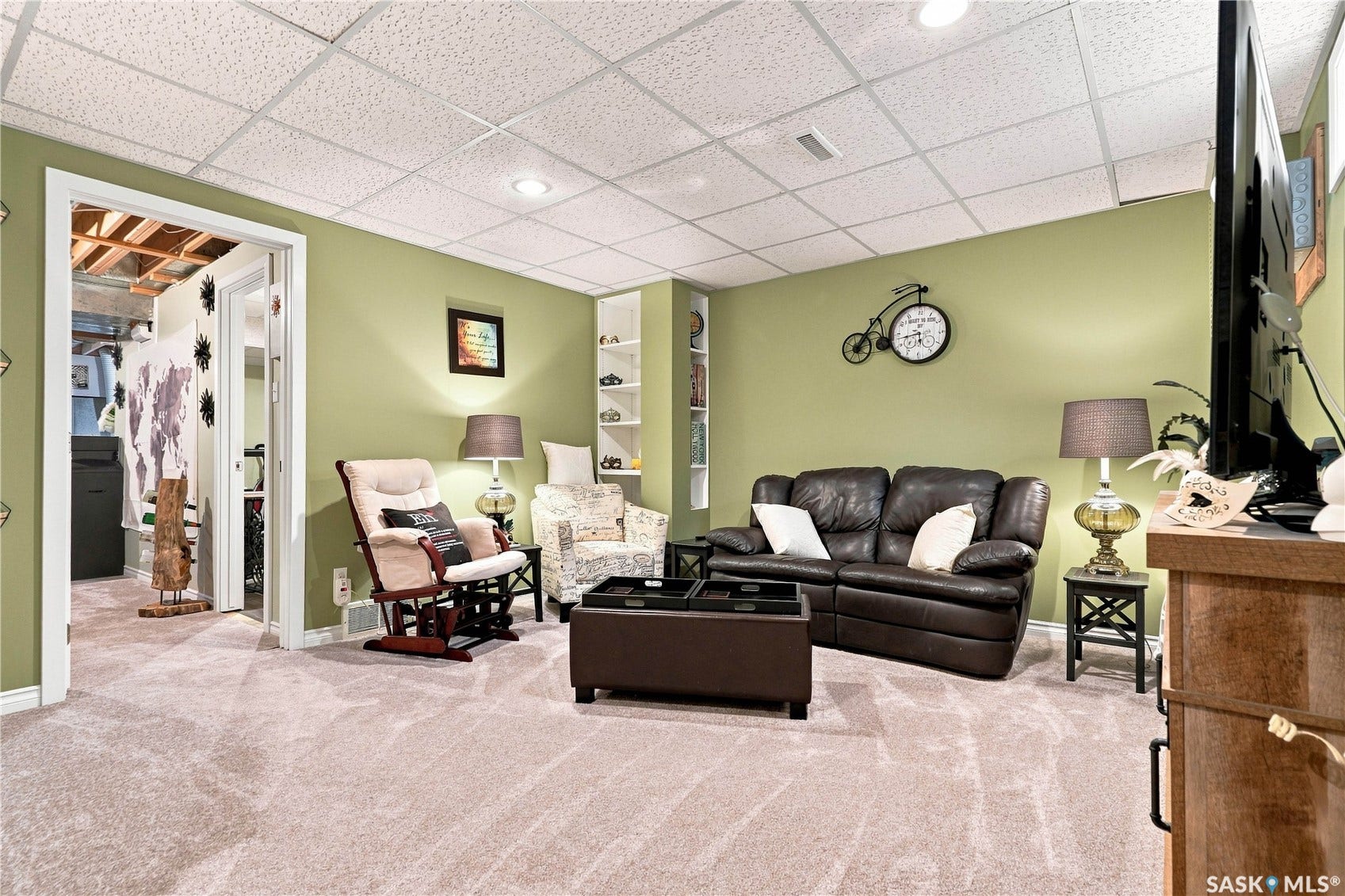 Recessed lighting illuminates the carpeted floor and painted walls