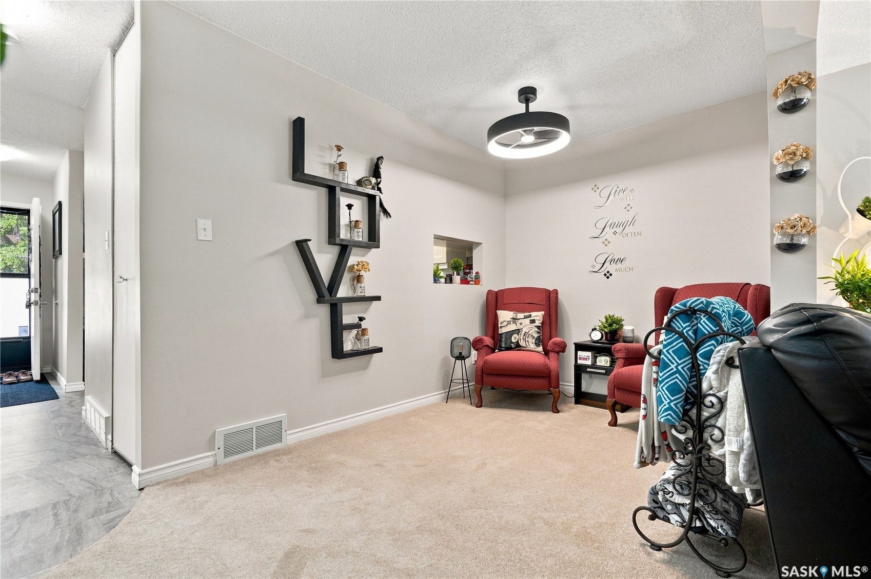 Carpeted flooring, recessed wall niche, and modern ceiling light fixture