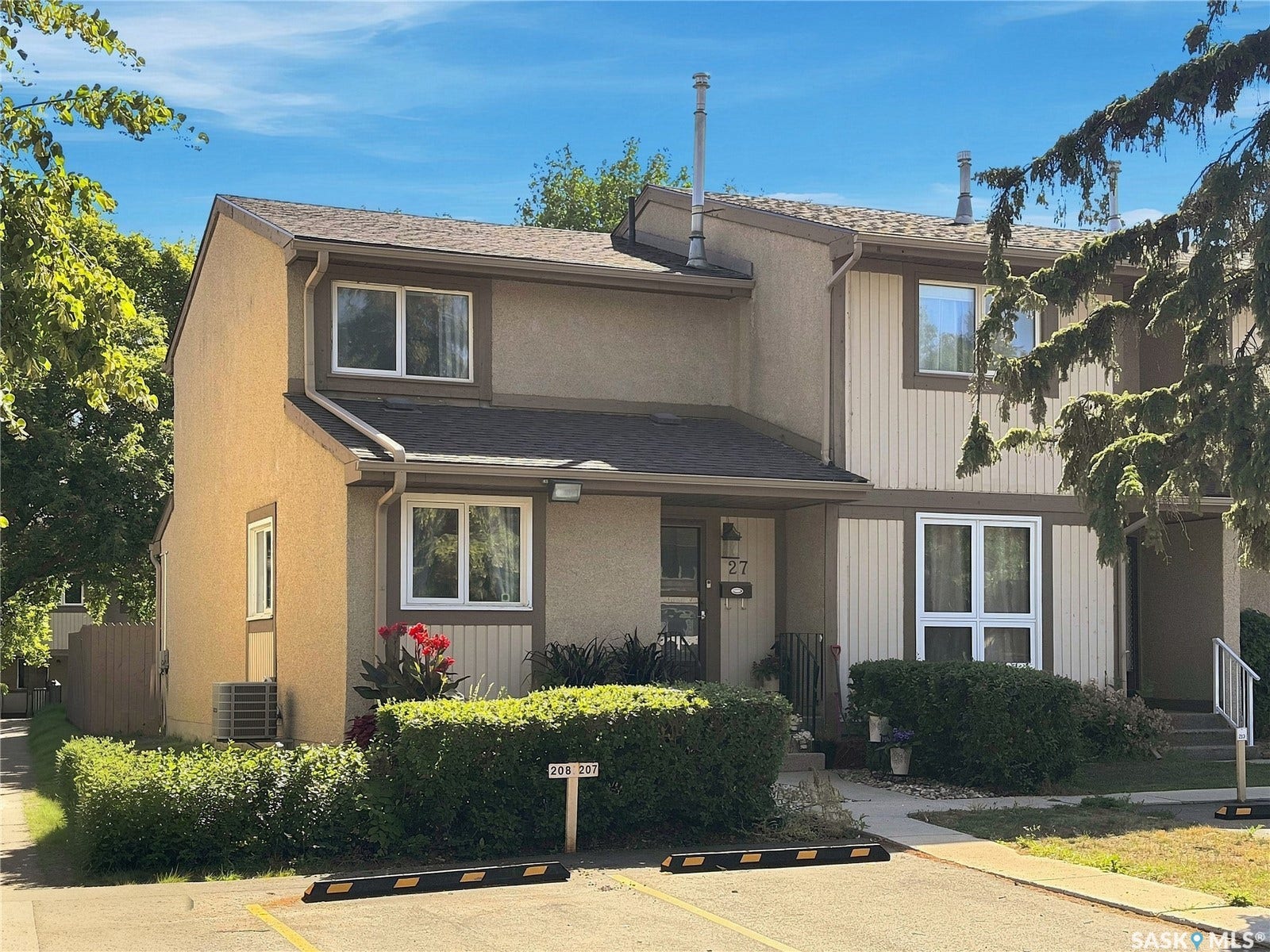 Multi-level exterior with stucco and vertical siding accents