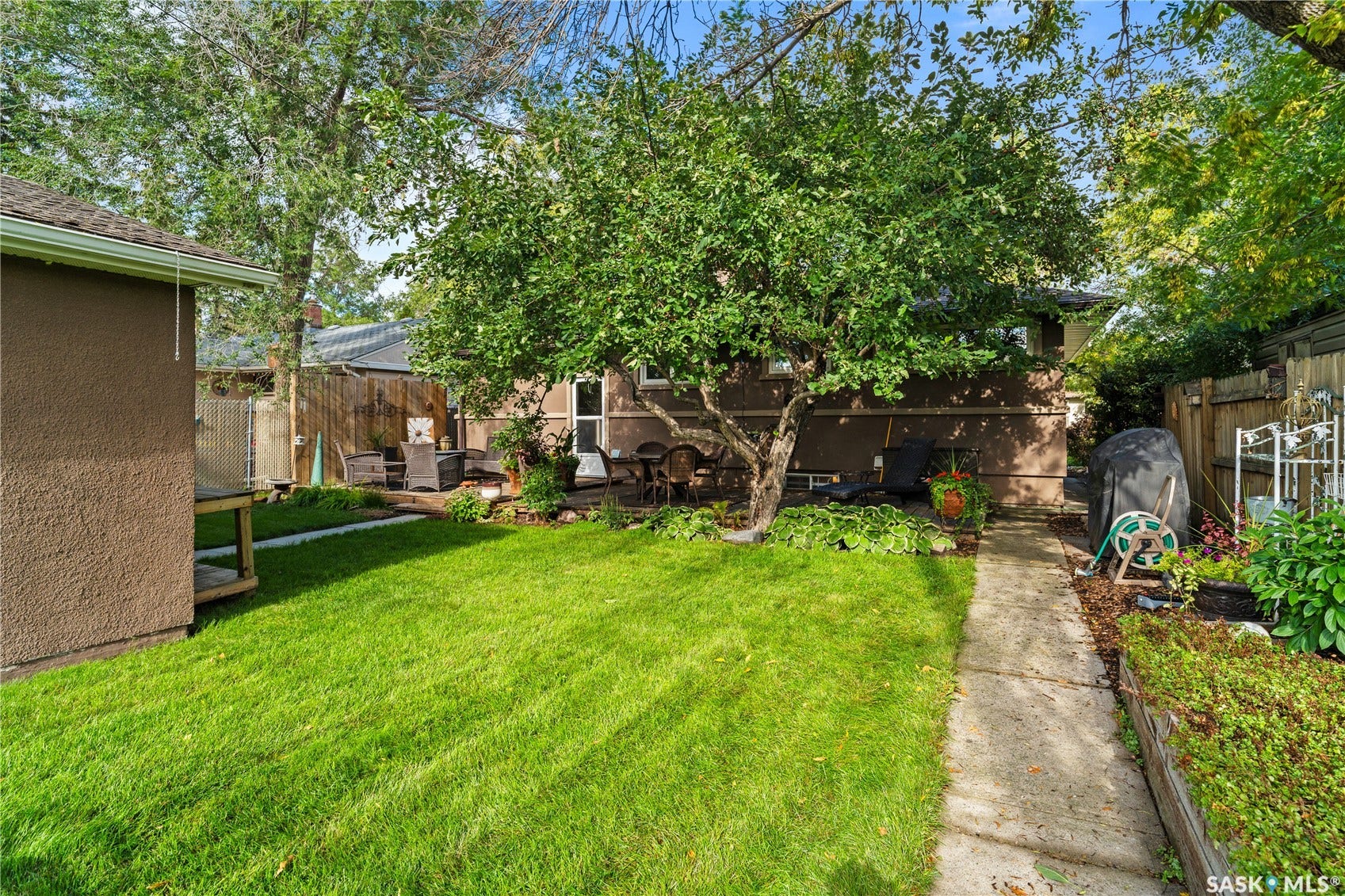 back of home with expansive yard and double detached garage