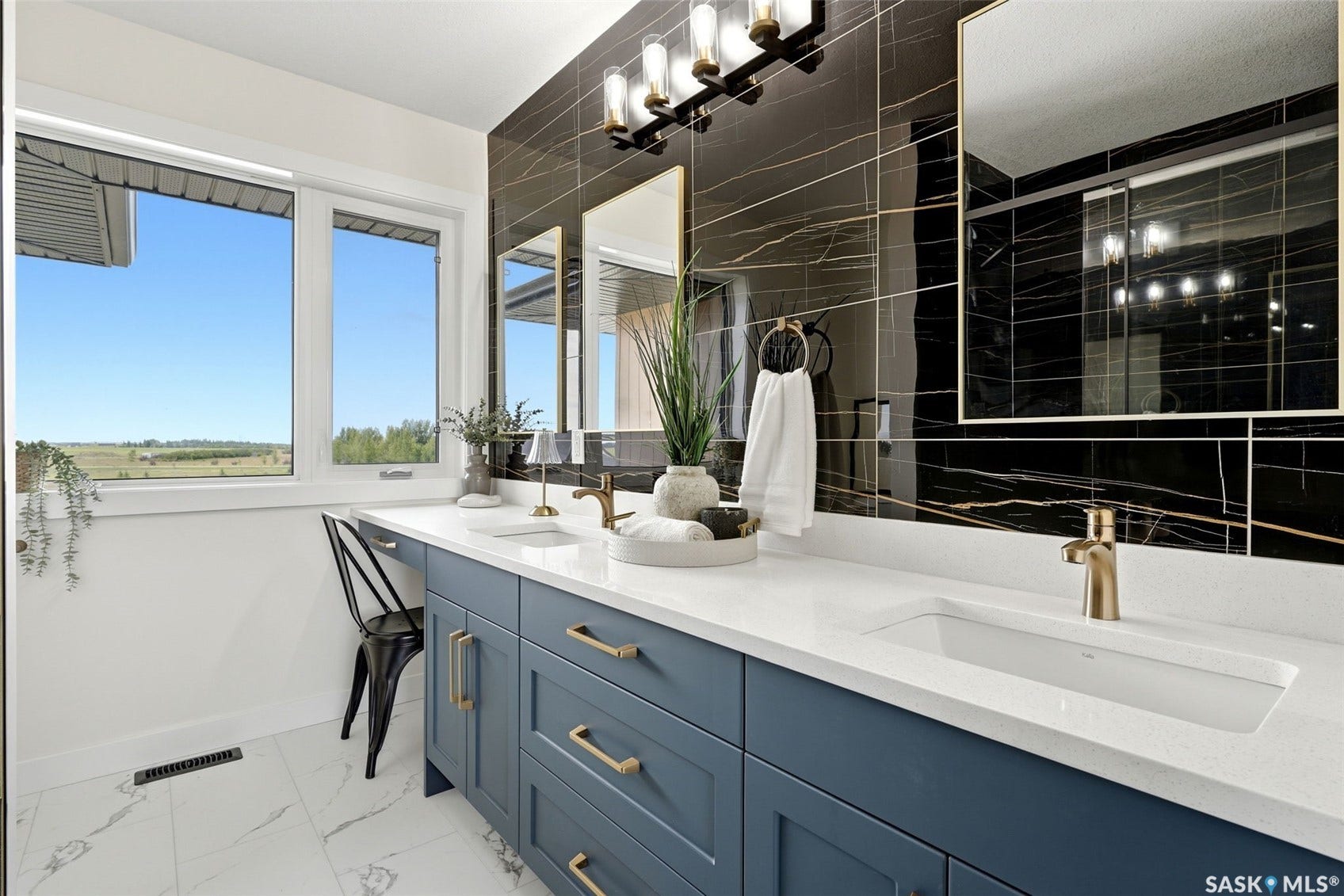 Dual vanity with white countertops, integrated sinks, and gold-tone faucets