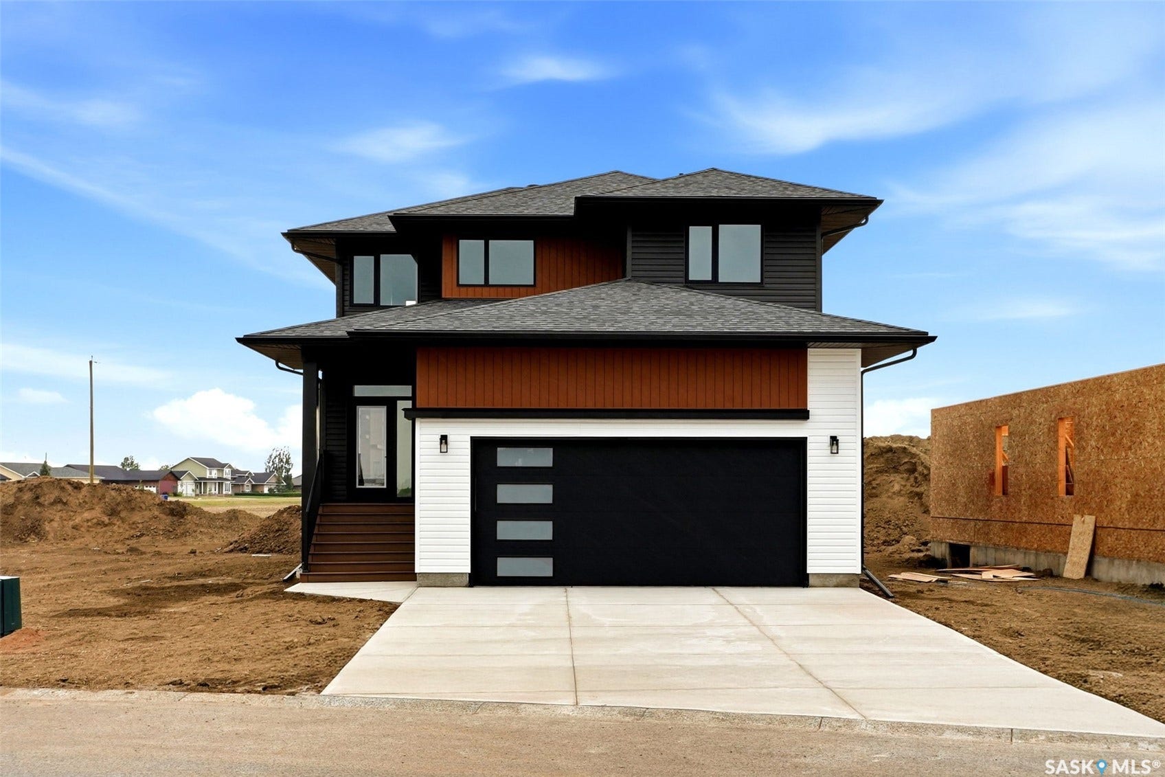 Contemporary exterior with dark siding, brown wood-finish accents, and white paneling