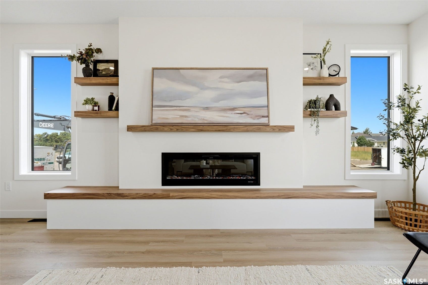 Built-in electric fireplace with a wood-finish mantel and hearth
